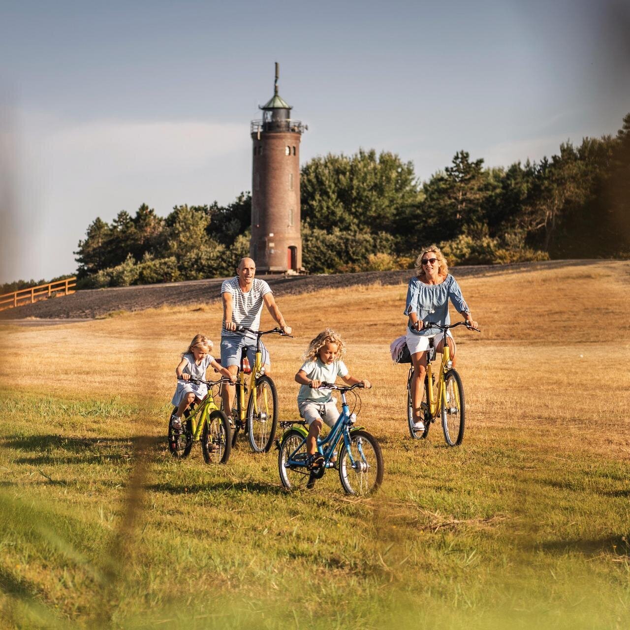 Familie beim Fahrradfahren vor dem Böhler Leuchtturm