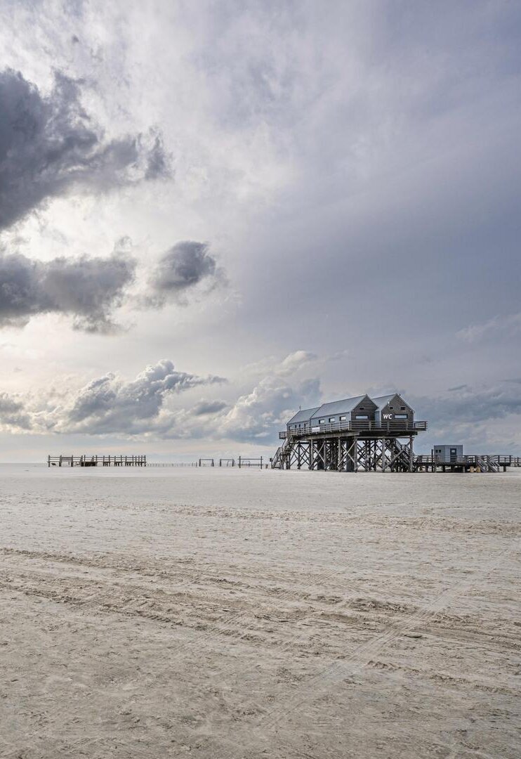Pfahlbau unter Wolken am Ordinger Strand