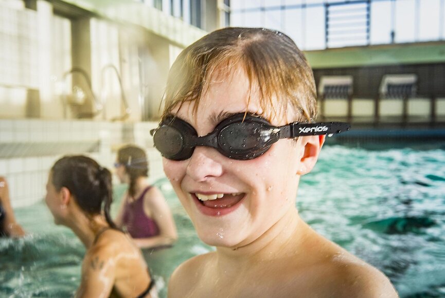 A boy wearing goggles in the adventure pool