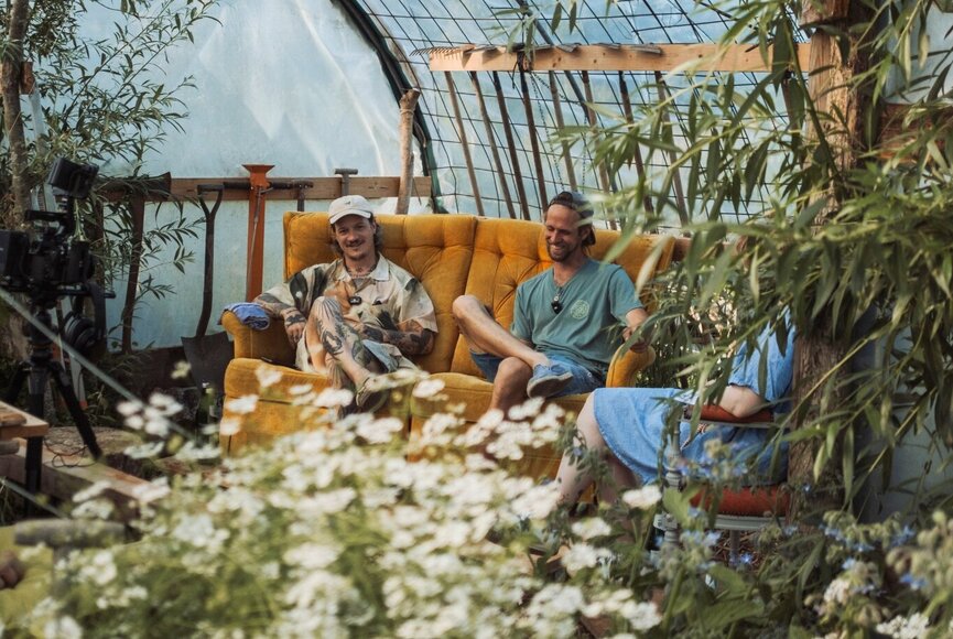 The three podcast hosts are sitting in the greenhouse during the recording